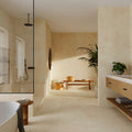 Modern bathroom with beige tiles, a freestanding bathtub, and wooden vanity.