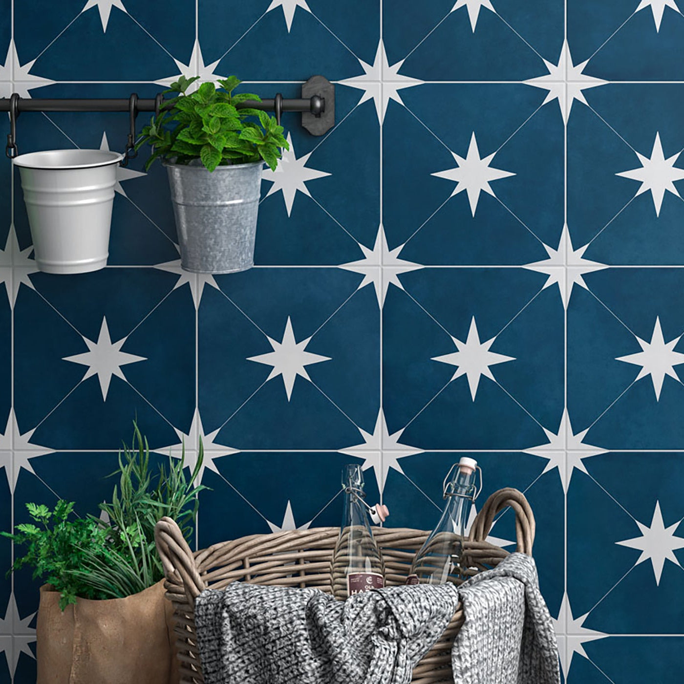 Navy blue wall with white star pattern, wicker basket, and plants.
