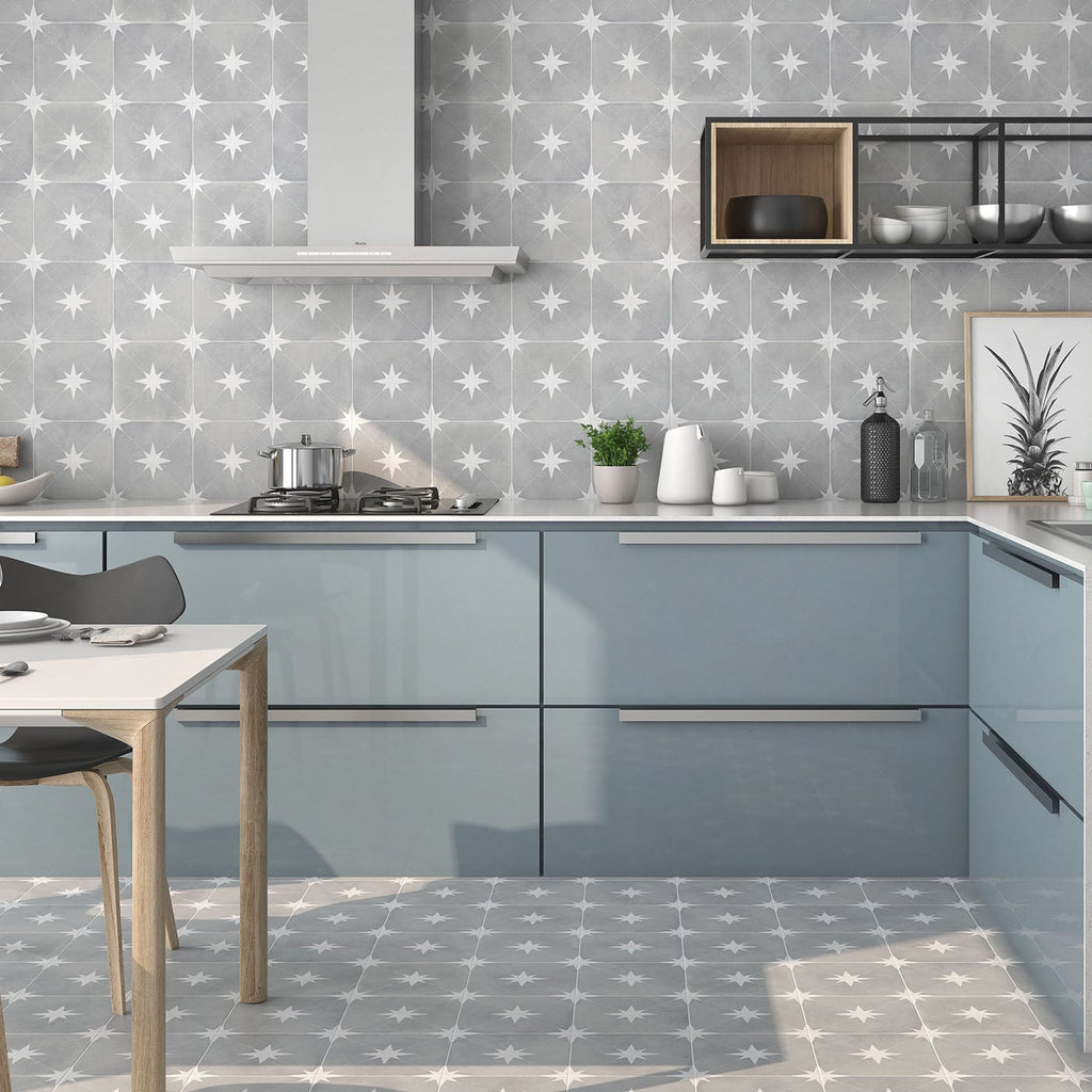 Modern kitchen with gray cabinets, white countertop, and patterned wallpaper.