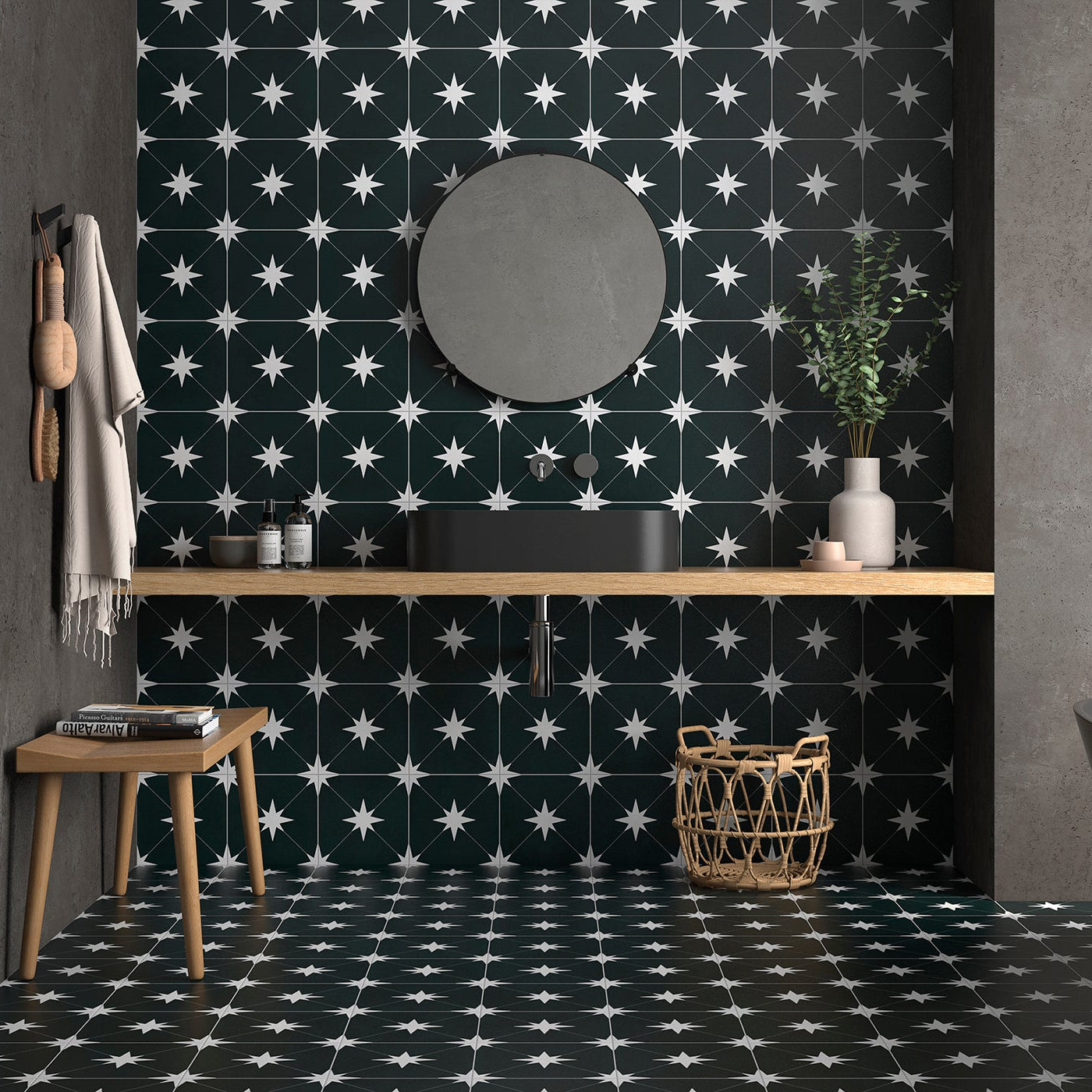 Modern bathroom with black and white patterned tiles, wooden vanity, and freestanding bathtub.
