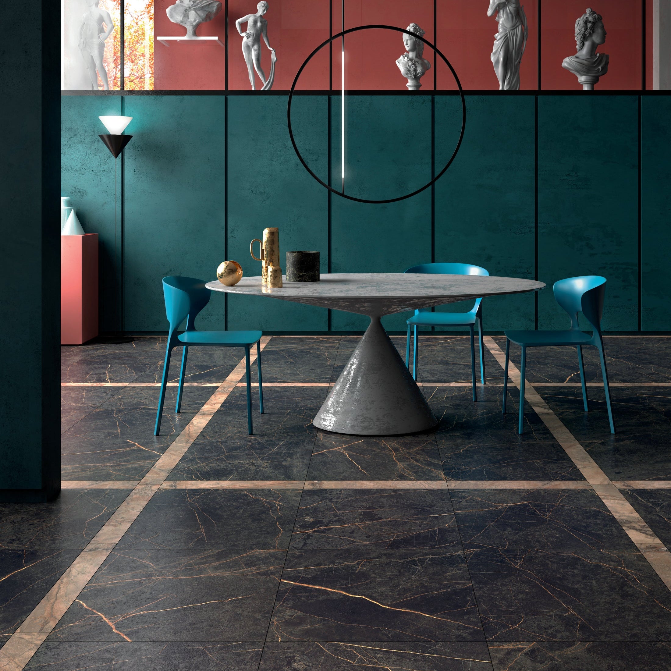 Modern dining area with a round table and green chairs against a geometric wall design.